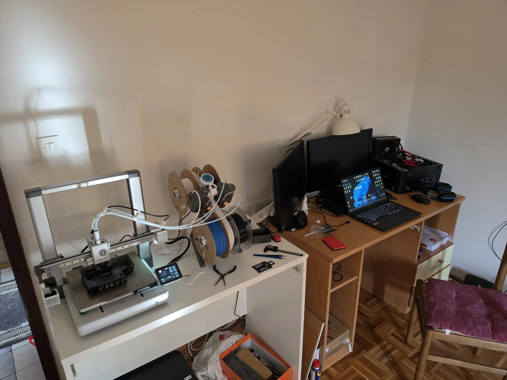 The 3D printing and design desk — printer, filament rack, calipers and the laptop rig